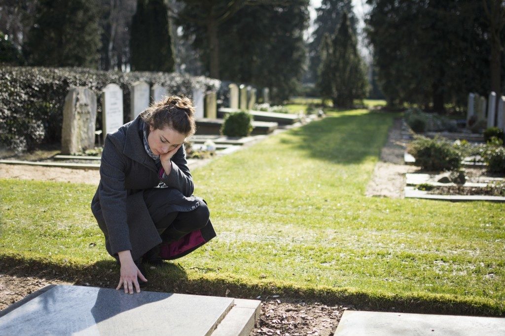 Woman visiting a grave